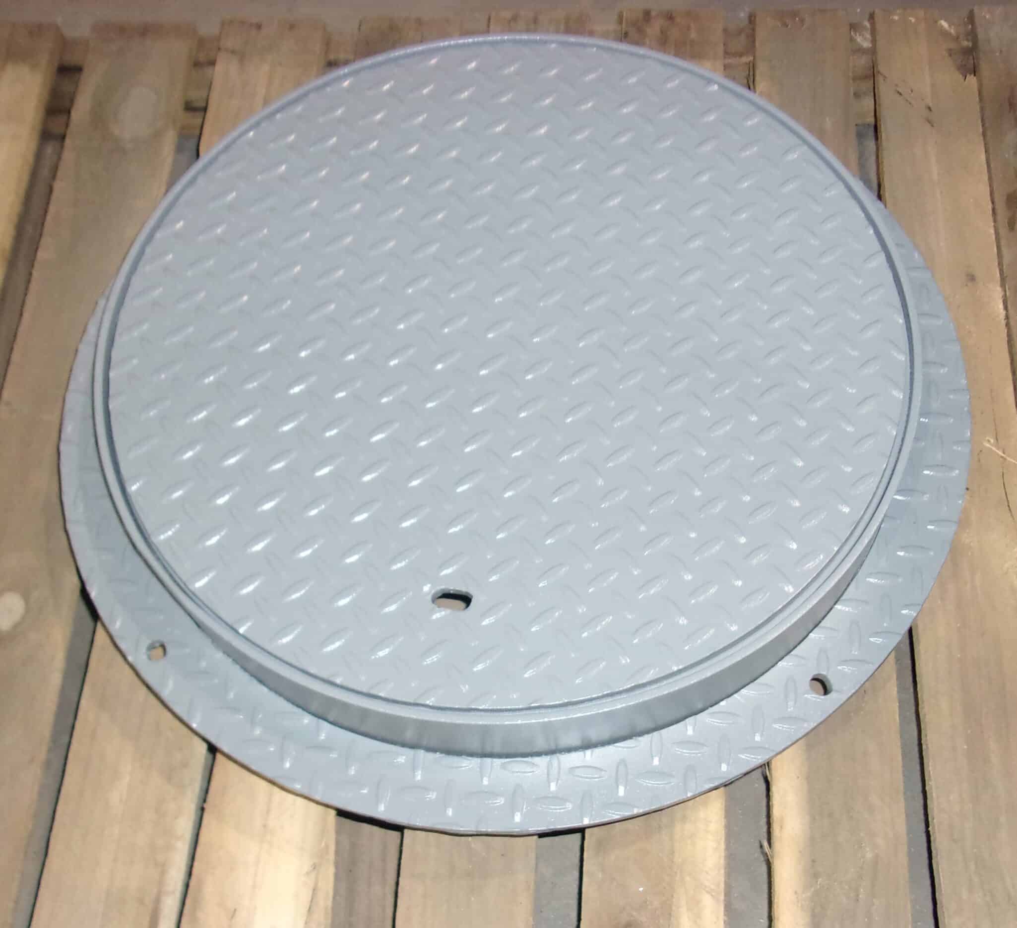 white manhole cover with frame and flange