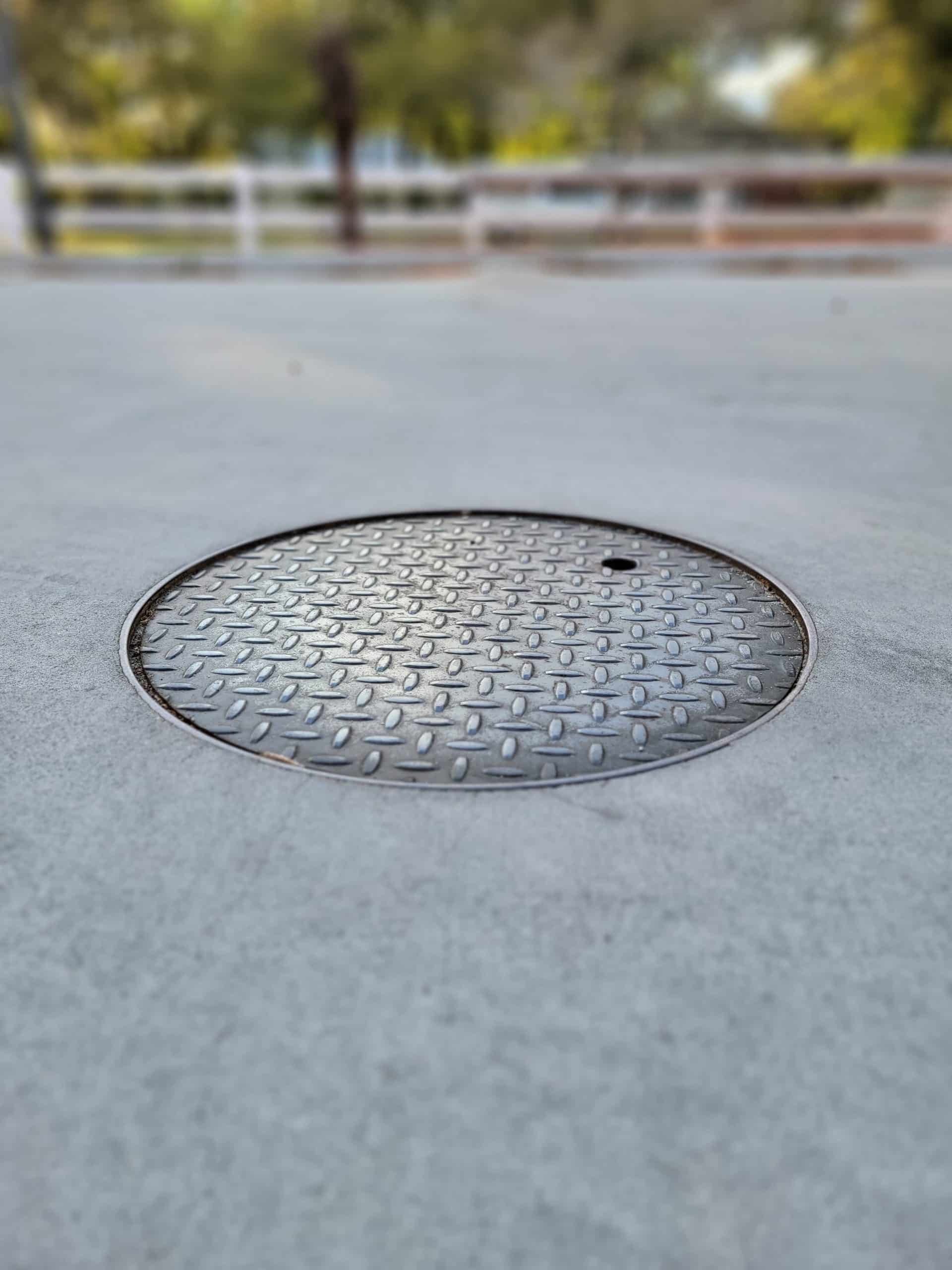 round sewer cover in pavement