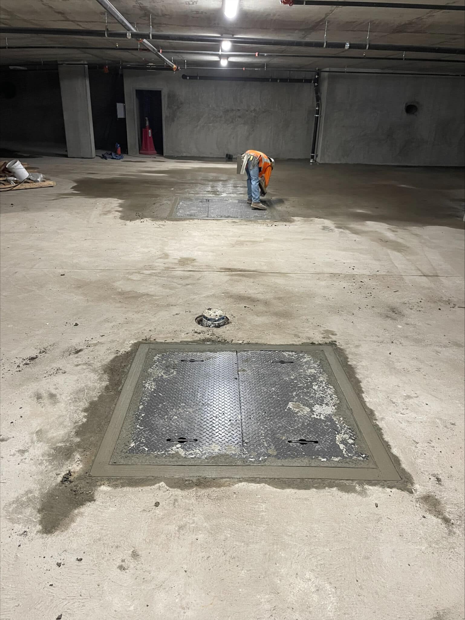 square manhole cover and frame set into concrete