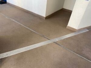 trench-drain-grate-covers-hotel-hallway